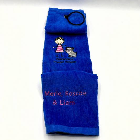 Gracie's Doggie Delights custom paw/drool towel. Blue towel with embroidered text and graphics on a white background